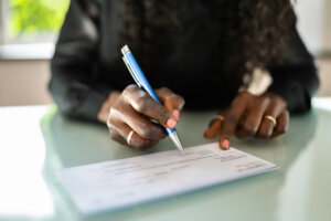African woman writing a check