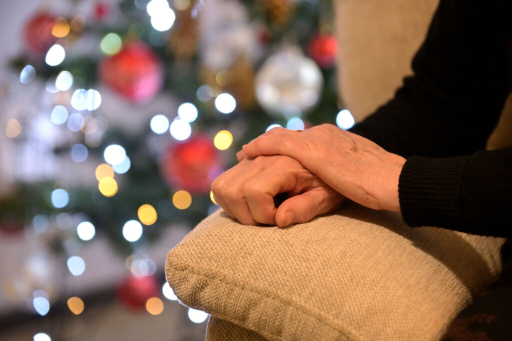 Close Up Of Hand Holding Illuminated Christmas Tree