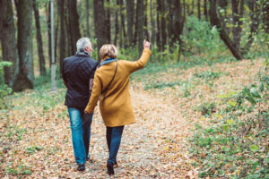 Back view of couple walking in autumn park