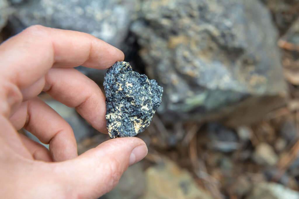 Piece of chromite ore in hand