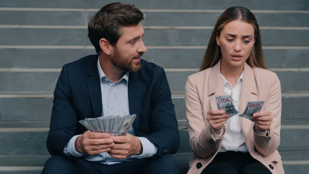Inequality money discrimination Caucasian man male guy business businessman happy with big dollars smile blink rich sad woman girl female businesswoman with little salary financial injustice in city