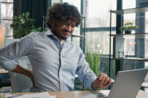 Man has back pain while working