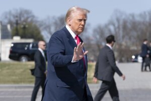 President Donald Trump waves to the media