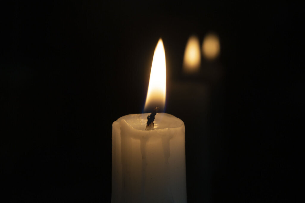 Close up of orange wax candle flame