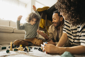 Family enjoying time together playing games in a living room.
