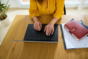 Woman manages tasks on her laptop in a serene home office