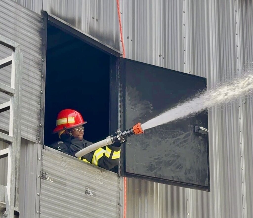 Teenager firing a water hose