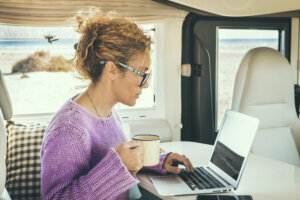 Portrait Of Young Woman Using Laptop At Home