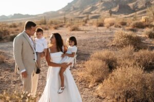 A woman in a wedding dress and her family