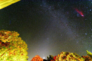 Pyramid shaped ghostly light with Venus and the Milky Way