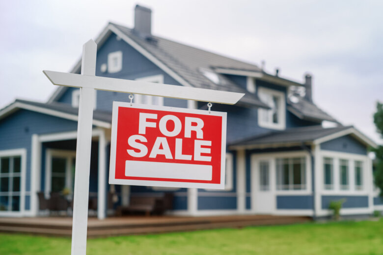 For Sale sign in front of a house