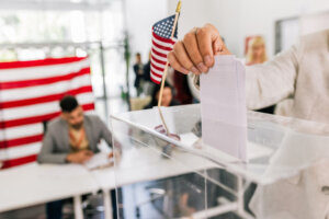 Voter placing ballot in ballot box
