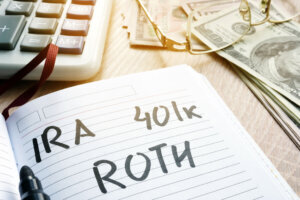 Words IRA 401k ROTH handwritten in a note