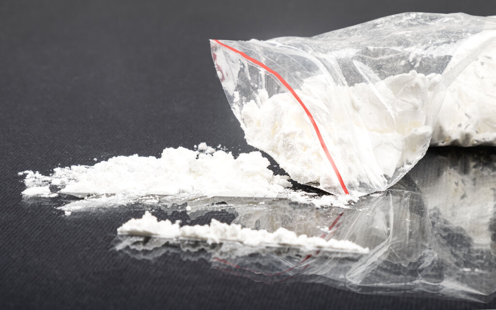Sprinkled white amphetamine powder, concept snuff drug addiction