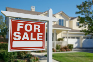 For sale sign in front of beautiful house