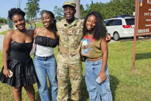 Michael Angu with his sisters