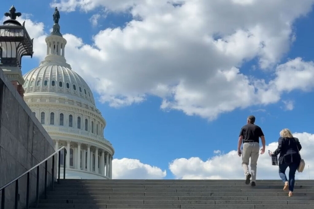 2 people walking up towards US Capitol