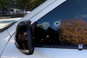 White Dodge SUV with bullet holes