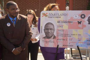Eric Carpenter Grantham stares at a replica of a new Maryland driver's license with his picture and a butterfly symbol