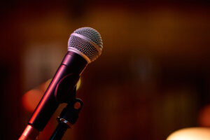 Microphone ready for a heavy metal concert with energetic crowd in background