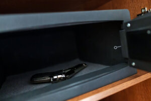Handgun lies in a metal safe.