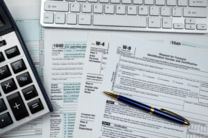 2022 blank 1040 us tax form with calculator and keyboard on office desk