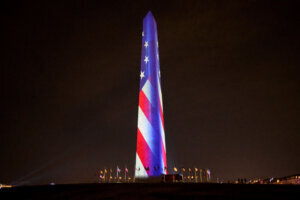 Washington Monument is illuminated with images