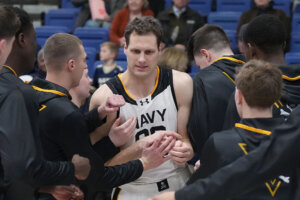 Aidan Kehoe (99) of the Navy Midshipmen is introduced before a college basketball game