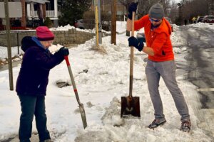 Two people shoveling snow.