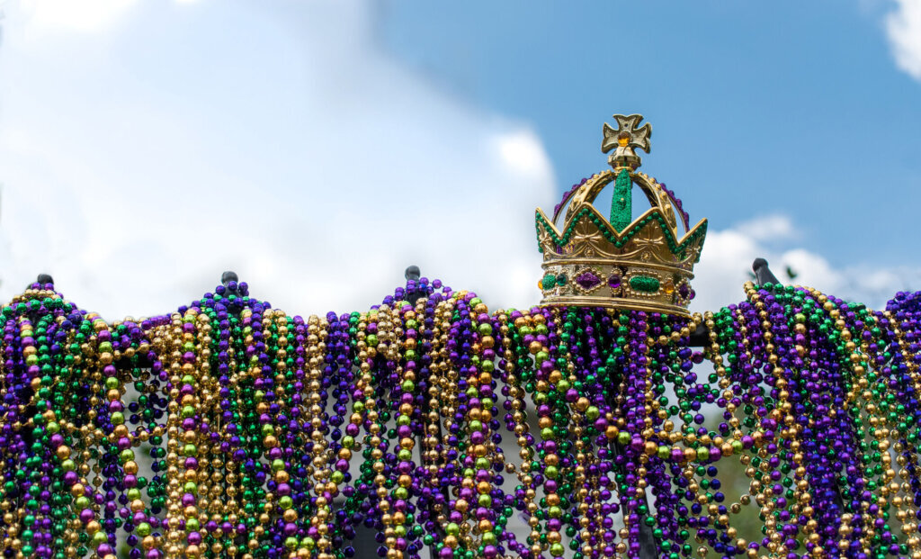 Iron fence covered with Mardi Gras beads