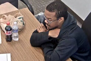 D.C. pipe bomb suspect Brian J. Cole Jr., being interrogated by FBI investigators at a table.