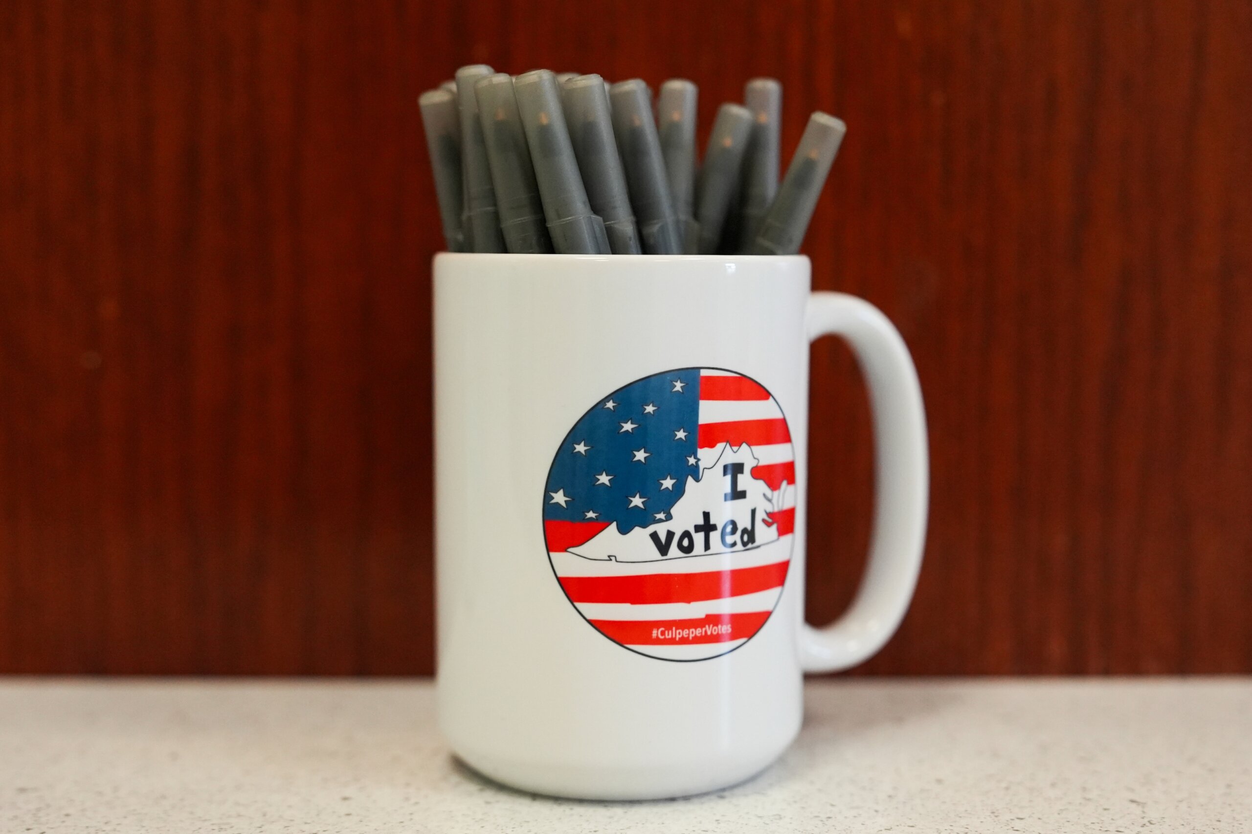 A mug holds pens at the Culpeper County Voter Registration officev