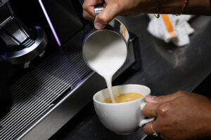 Barista pours a latte