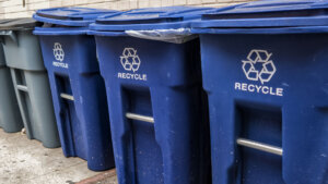 Blue garbage bins with the white recycle logo