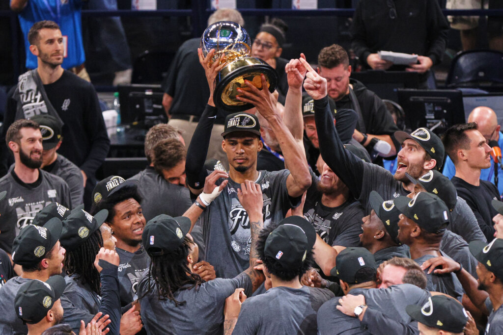 San Antonio Spurs forward Victor Wembanyama holds up the trophy