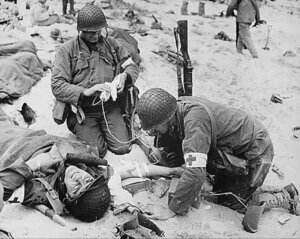 Combat medics help an injured soldier in France (courtesy of National archives)