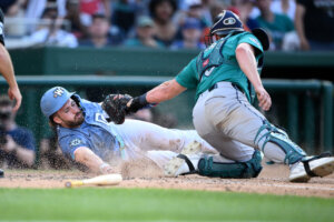 Washington Nationals' Dylan Crews, left, is safe at home plate