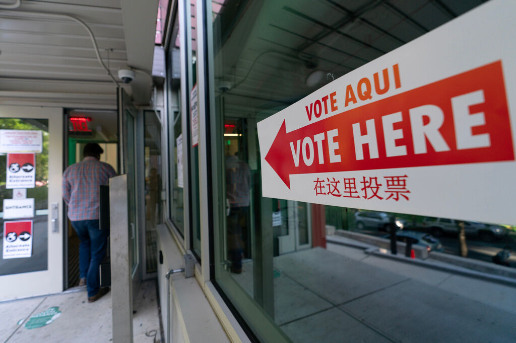 People arrive to their polling station during D.C. primary election at Shepherd Elementary, Tuesday, June 16, 2026, in Washington. (AP Photo/Jose Luis Magana)