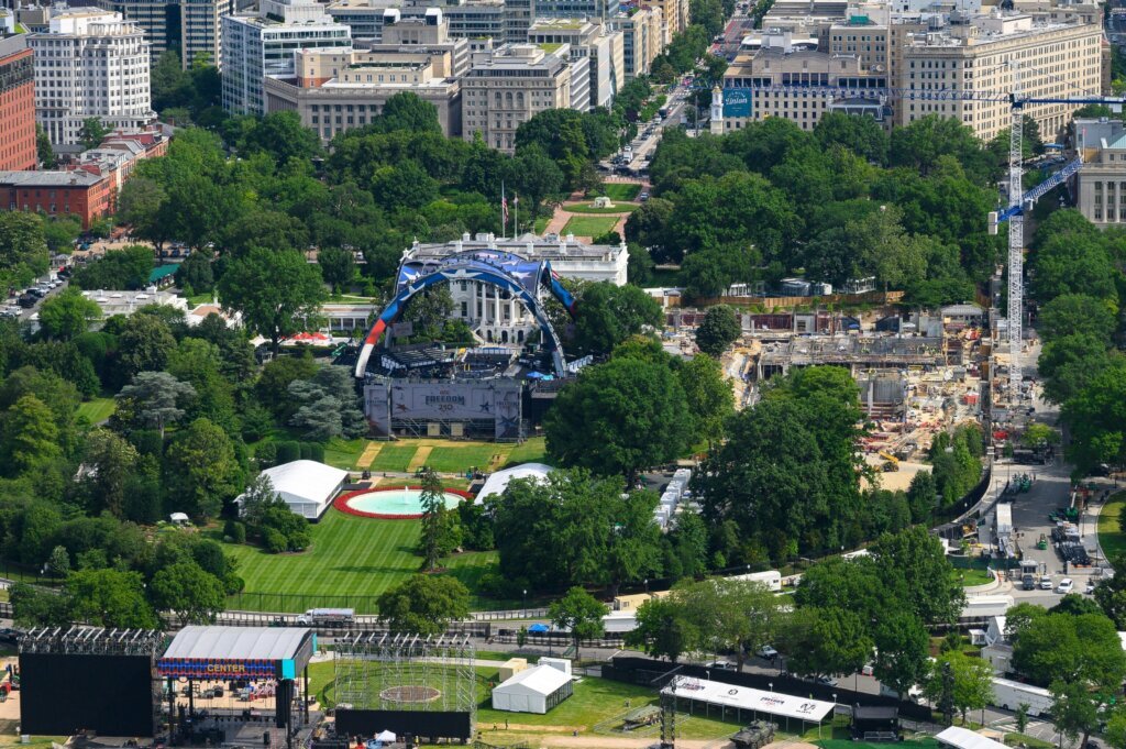 Workers continue building the stage for a future UFC fight on the South Lawn of the White House, center, Tuesday, June 9, 2026, in Washington, as work also continues on the construction of the ballroom, right. (AP Photo/Cliff Owen)
