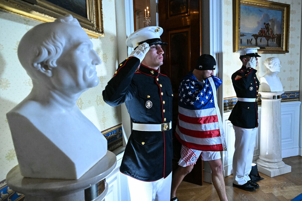 US Marines salute as America's Justin Gaethje walks into the Blue Room of the White House before the start of his lightweight title bout against Georgia's Ilia Topuria during the "UFC Freedom 250" mixed martial arts event in Washington, DC, in the early hours of June 15, 2026. (Photo by SAUL LOEB / POOL / AFP via Getty Images)