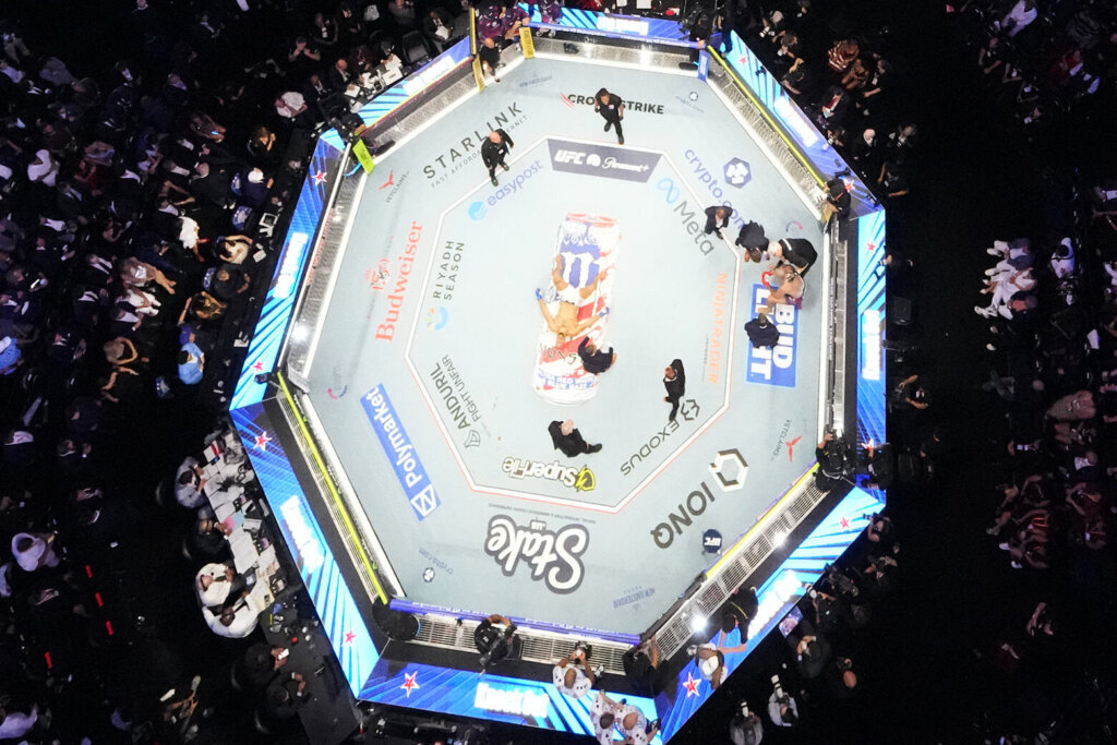Ciryl Gane lies in the center of the ring as Alex Pereira (R) is attended to during the UFC Freedom 250 fights on the South Lawn of the White House on June 15, 2026, in Washington, DC. (Photo by Alex Brandon-Pool/Getty Images)