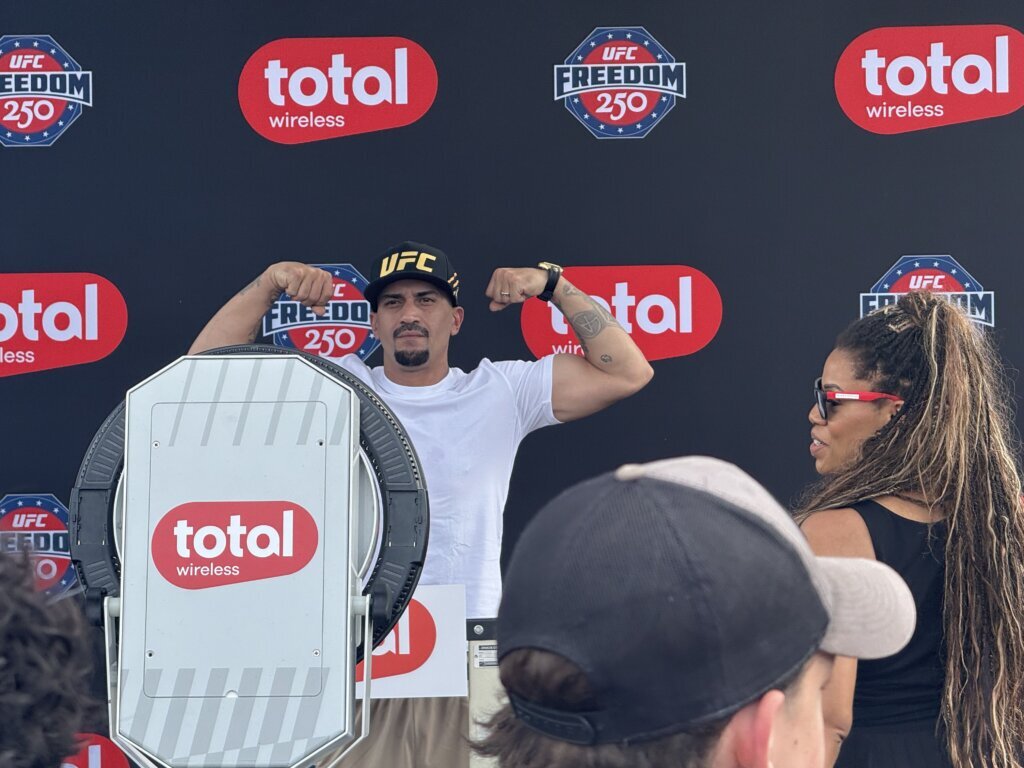 Fan fest attendees pose at a step-and-repeat. (WTOP/Jimmy Alexander)