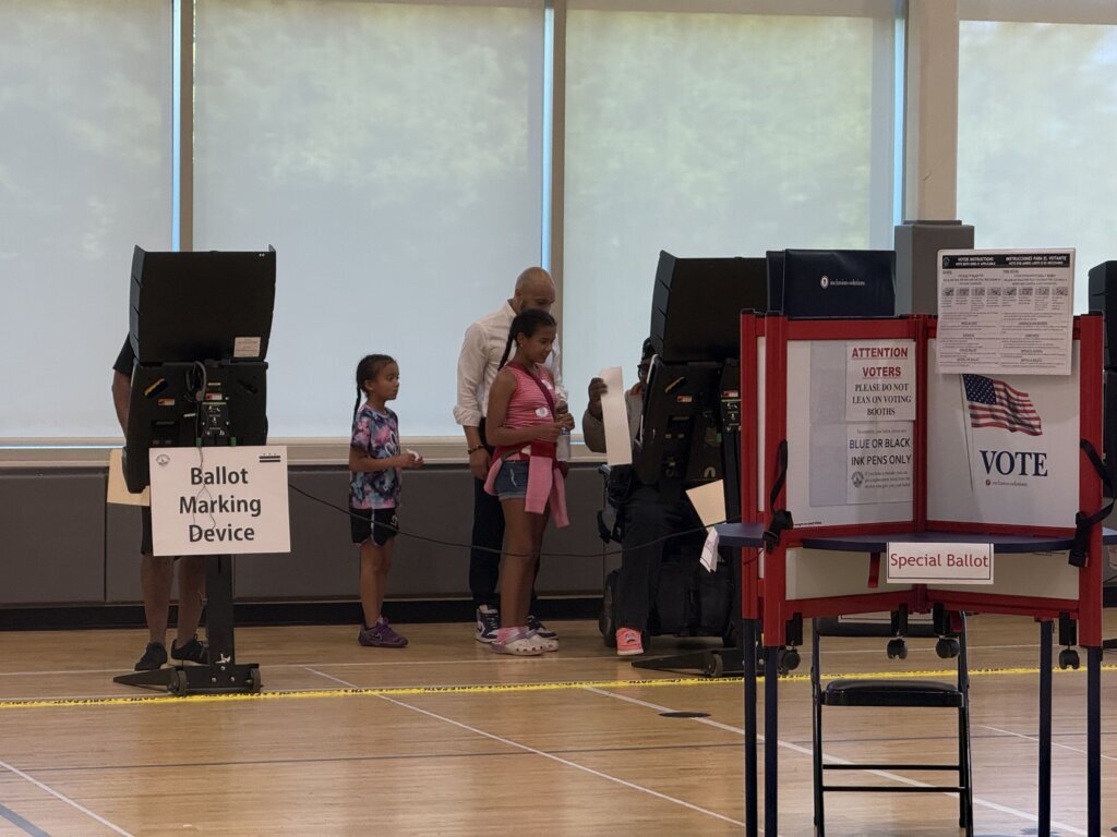 Voting is a family affair. D.C. Council member Robert White Jr. approaches voting booth with his young daughters Tuesday, June 16, 2026, in Washington.