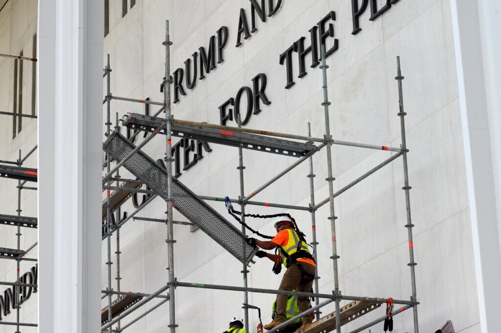 Workers erect scaffolding in front of the John F. Kennedy Center for the Performing Arts sign in Washington, Friday, June 12, 2026. (AP Photo/Cliff Owen)