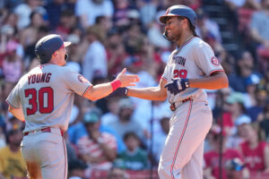 Washington Nationals' James Wood is congratulated by Jacob Young