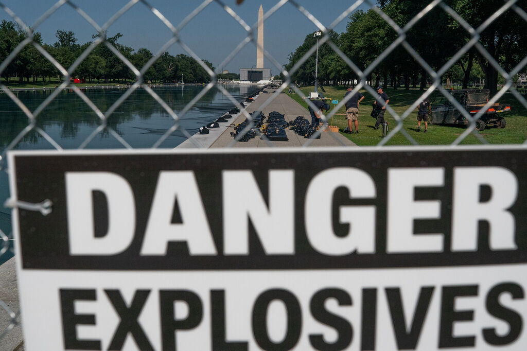 Workers installed fireworks along the edge of the Lincoln Memorial Reflecting Pool ahead of the America 250 July 4th celebration on the National Mall, Thursday, July 2, 2026, in Washington. (AP Photo/Nathan Howard)