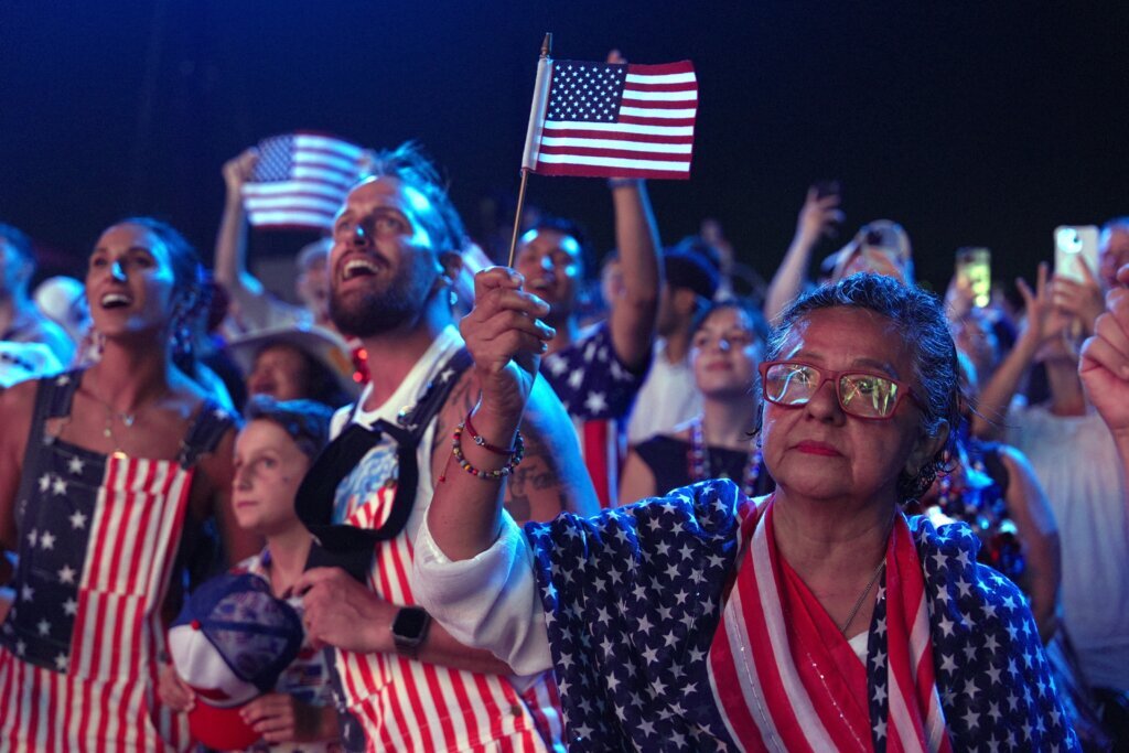 Guests dressed in American flag-themed clothes attend Salute to America, an Independence Day event honoring the nation's 250th anniversary, Saturday, July 4, 2026, on the National Mall in Washington. (AP Photo/Mark Schiefelbein)