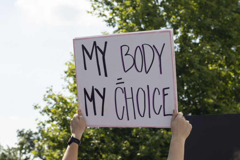 Woman holding "My Body, My Choice" sign