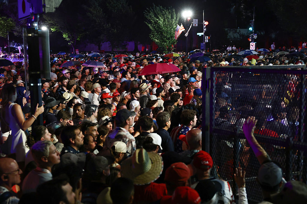 Visitors gather at the security barriers to re-enter the National Mall for the "Salute to America 250" Fourth of July celebrations after officials instructed everyone to evacuate the area due to severe weather on July 04, 2026 in Washington, D.C. (Photo by Finn Gomez/Getty Images)
