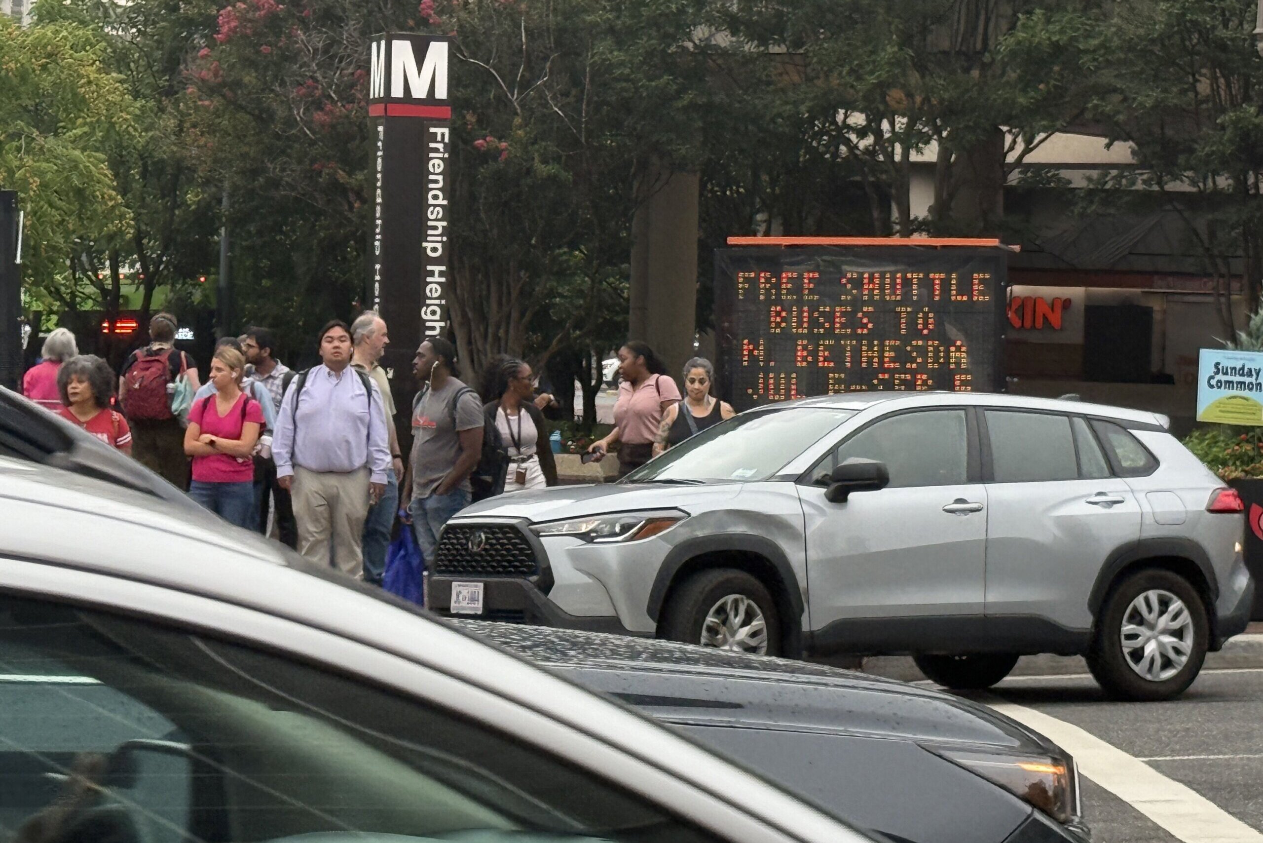 Riders prepare to board shuttle buses near the Friendship Heights station